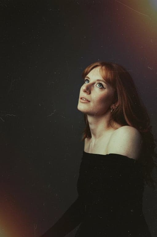 a portrait of a person reimagined in a retro camera style with reduced clarity, uneven tones, and nostalgic imperfections