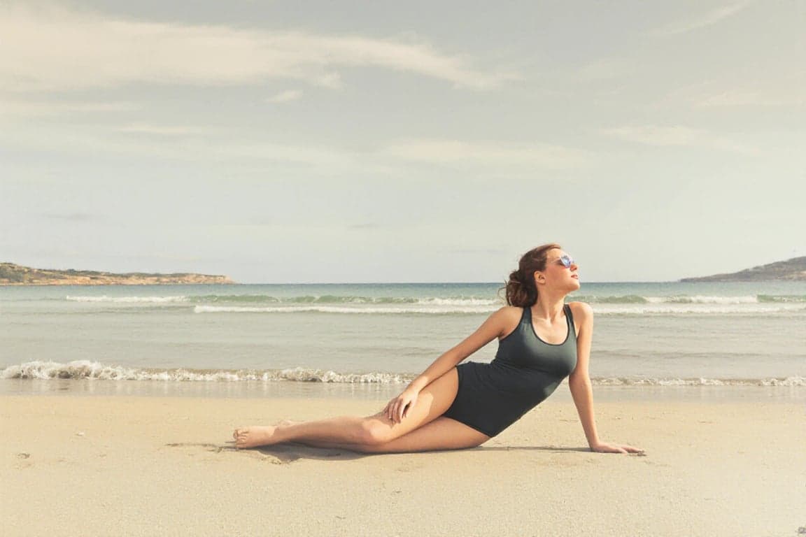 a portrait of a person edited to display a new bathing suit style, focusing on realistic fit, smooth seams, clear garment structure, neutral pose, and uncluttered background