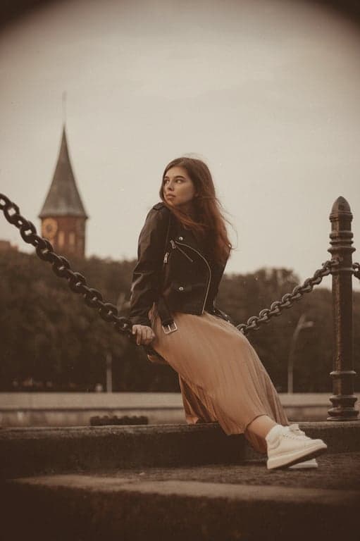 a portrait of a person edited with vintage camera characteristics, including soft focus edges, color fading, mild blur, and visible grain structure