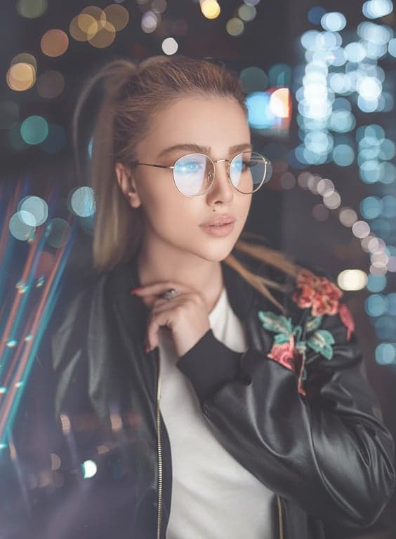An Instagram aesthetic portrait of a woman, using a soft light filter to create a cohesive feed look, matte finish, softened contrasts, pleasing pastel tones.