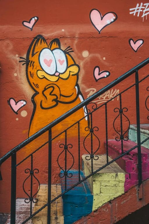 An image of Garfield the cat with the face of a crying Wojak, holding a glowing stick of butter, in a liminal space backroom, with the text \"I've seen the patterns\".