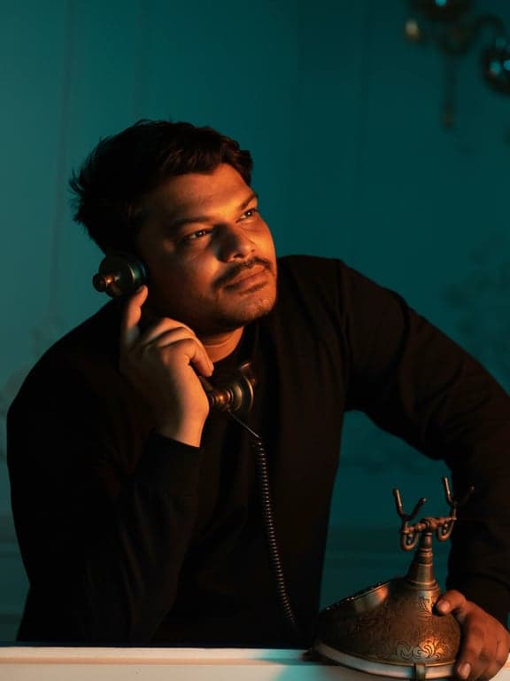 a portrait of a man, teal background with orange key light on face, high contrast, cinematic vibe, detailed skin texture.