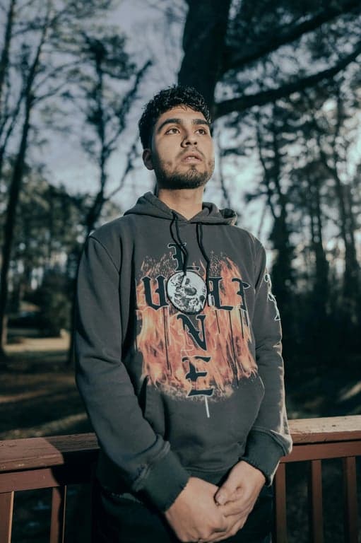 a portrait of a person illustrated in a Marvel Rivals–inspired hero game style with semi-realistic anatomy, smooth stylized skin, strong facial definition, cinematic game lighting, vibrant color grading, and a polished competitive hero shooter appearance