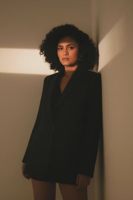 a portrait of a person enhanced to appear confident and professional, with corrected posture, natural facial proportions, subtle contrast, soft studio light, minimal background, and business-appropriate visual tone