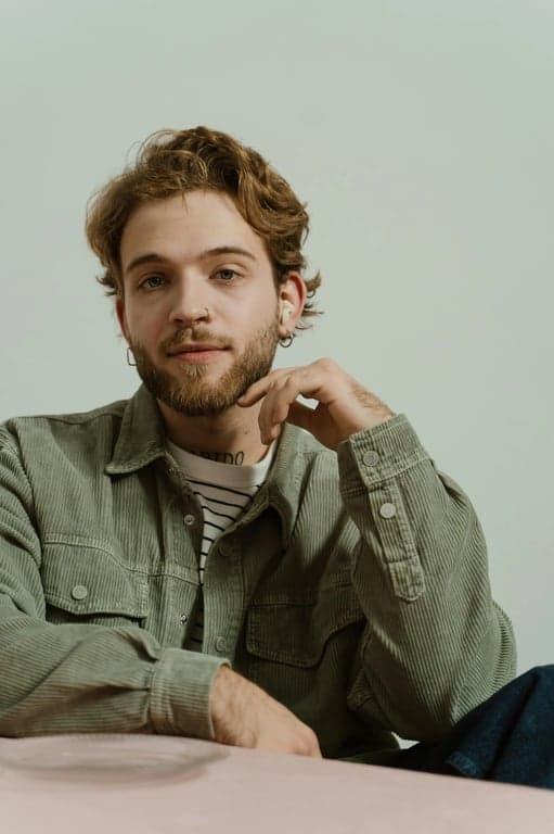 a portrait of a person transformed with black hair color, featuring deep neutral black tones, preserved highlights, visible strand separation, realistic shine, and natural root continuity