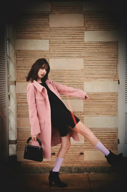 a portrait of a person with a Lomography camera filter, featuring highly saturated colors, dramatic vignetting, and random light leak streaks