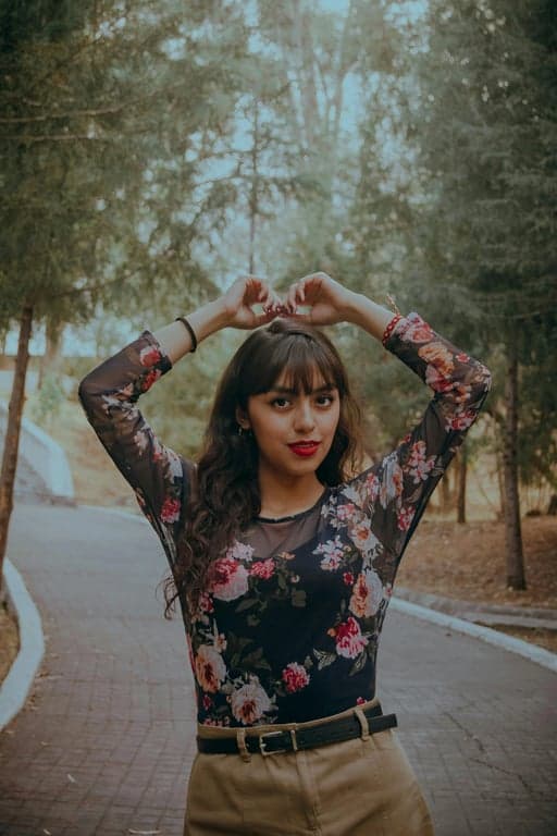 a portrait of a person rendered in a true Adventure Time-style cartoon art aesthetic, using rubbery elastic limbs, exaggerated head-to-body proportions, simple geometric shapes, tiny dot eyes, minimal mouth detail, bold hand-drawn linework, flat pastel-to-bright color palette, and a slightly absurd surreal animation vibe.